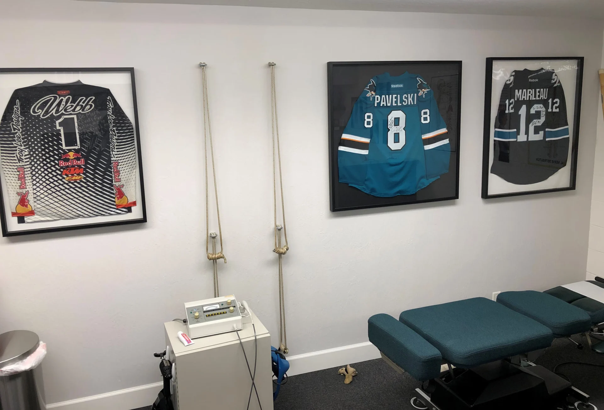 A health care facility with framed jerseys hanging on the wall